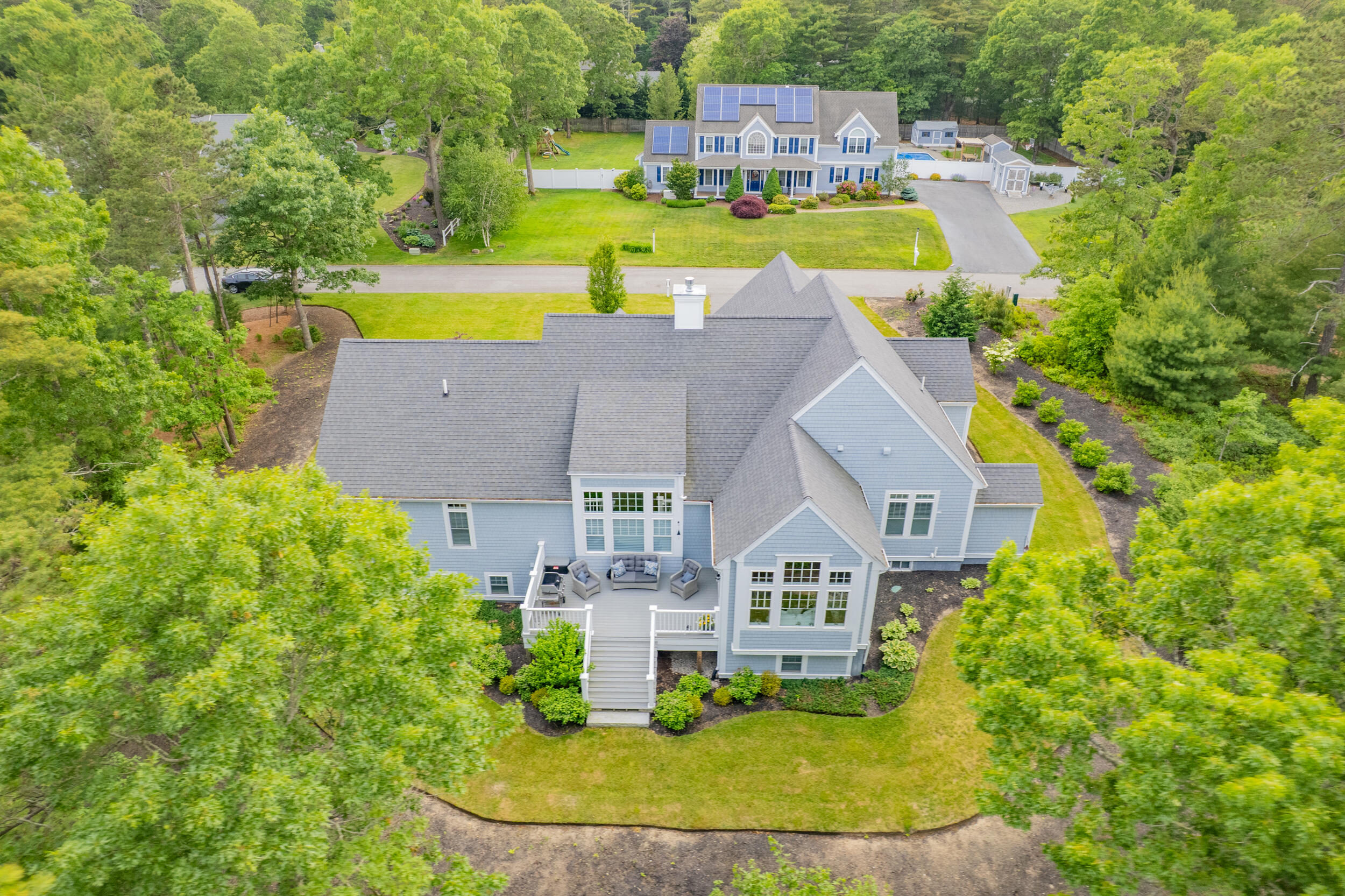 22 Camden Lane Mashpee, MA 02649 - Photo 3 of 46 an aerial view of a house with a swimming pool a yard and lake view