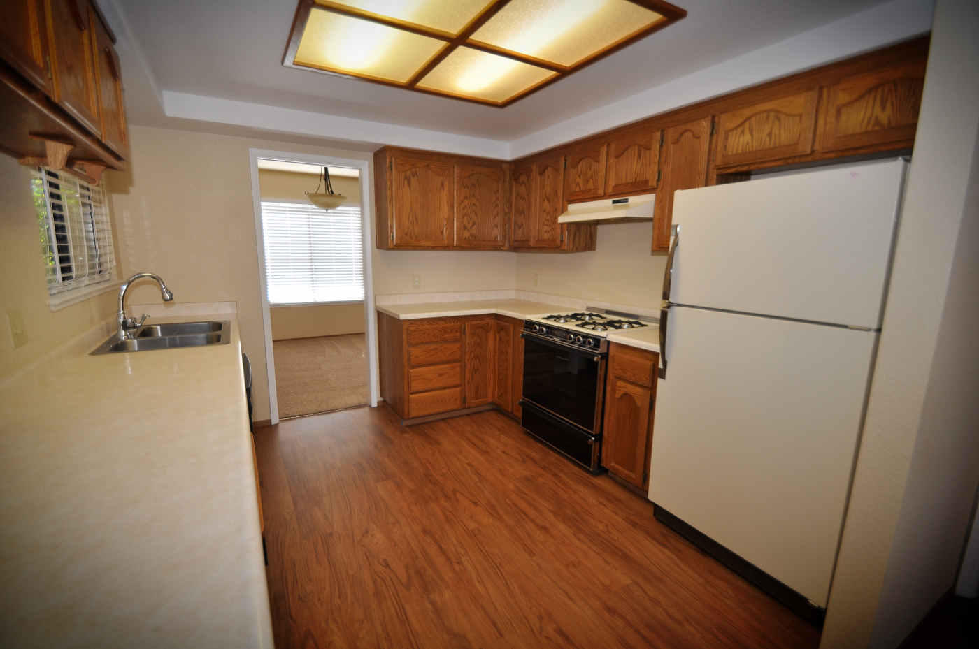 2867 Camulos Way Redding, CA 96002 - Photo 2 of 13 a kitchen with a refrigerator a stove top oven a sink and dishwasher