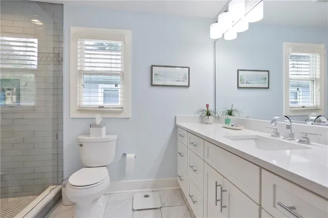 a view of a patio with table and chairs and a barbeque