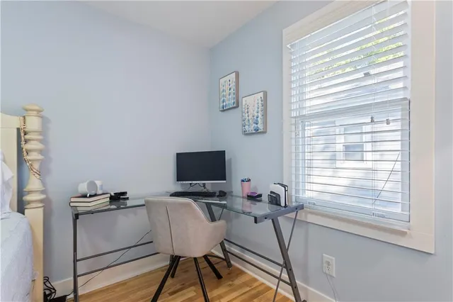 an aerial view of a house with a yard and a large tree