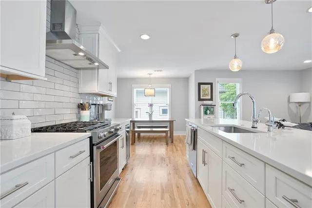 a living room with furniture kitchen and a chandelier