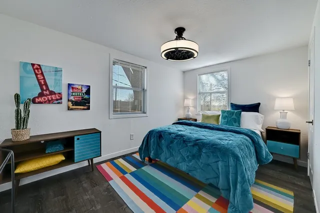 a bedroom with a bed and a chandelier