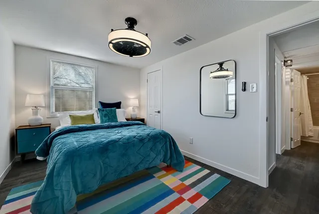 a bedroom with a bed a table and chair