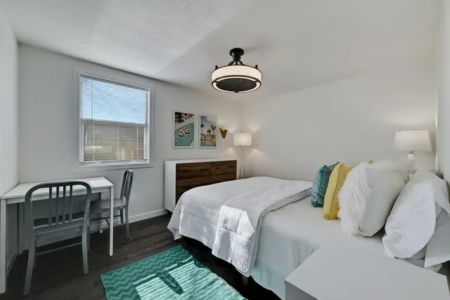 a bathroom with a sink toilet vanity and shower