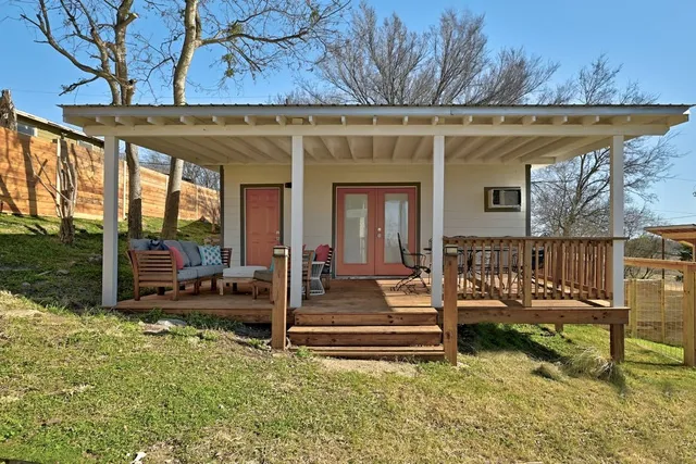 a view of a house with backyard porch and sitting area