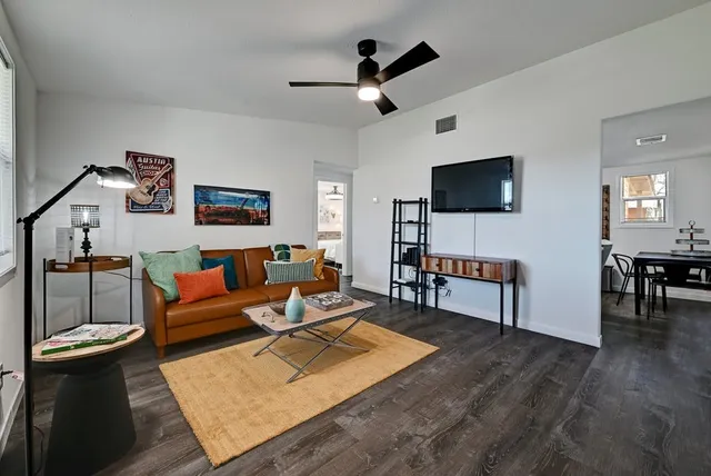 a living room with furniture and wooden floor