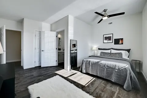 a bedroom with a bed and wooden floor