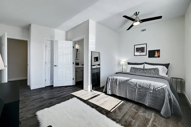 a bedroom with a bed and wooden floor