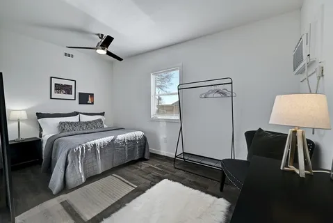 a bedroom with a bed and a chandelier