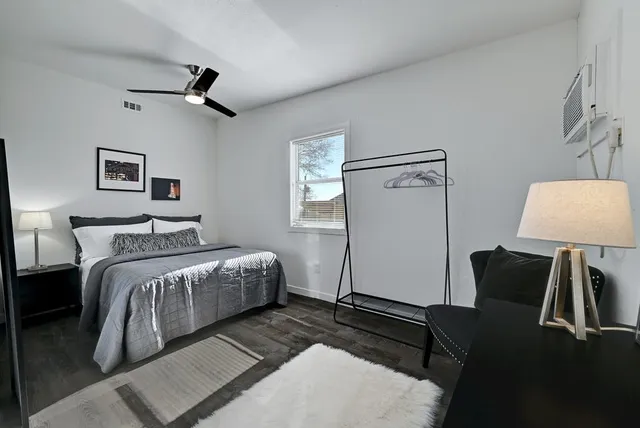 a bedroom with a bed and a chandelier