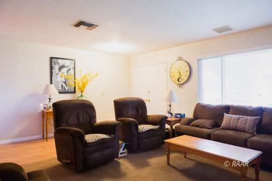 534 South Erin Street Ridgecrest, CA 93555 - Photo 5 of 29 a living room with furniture a couch and paintings on the wall