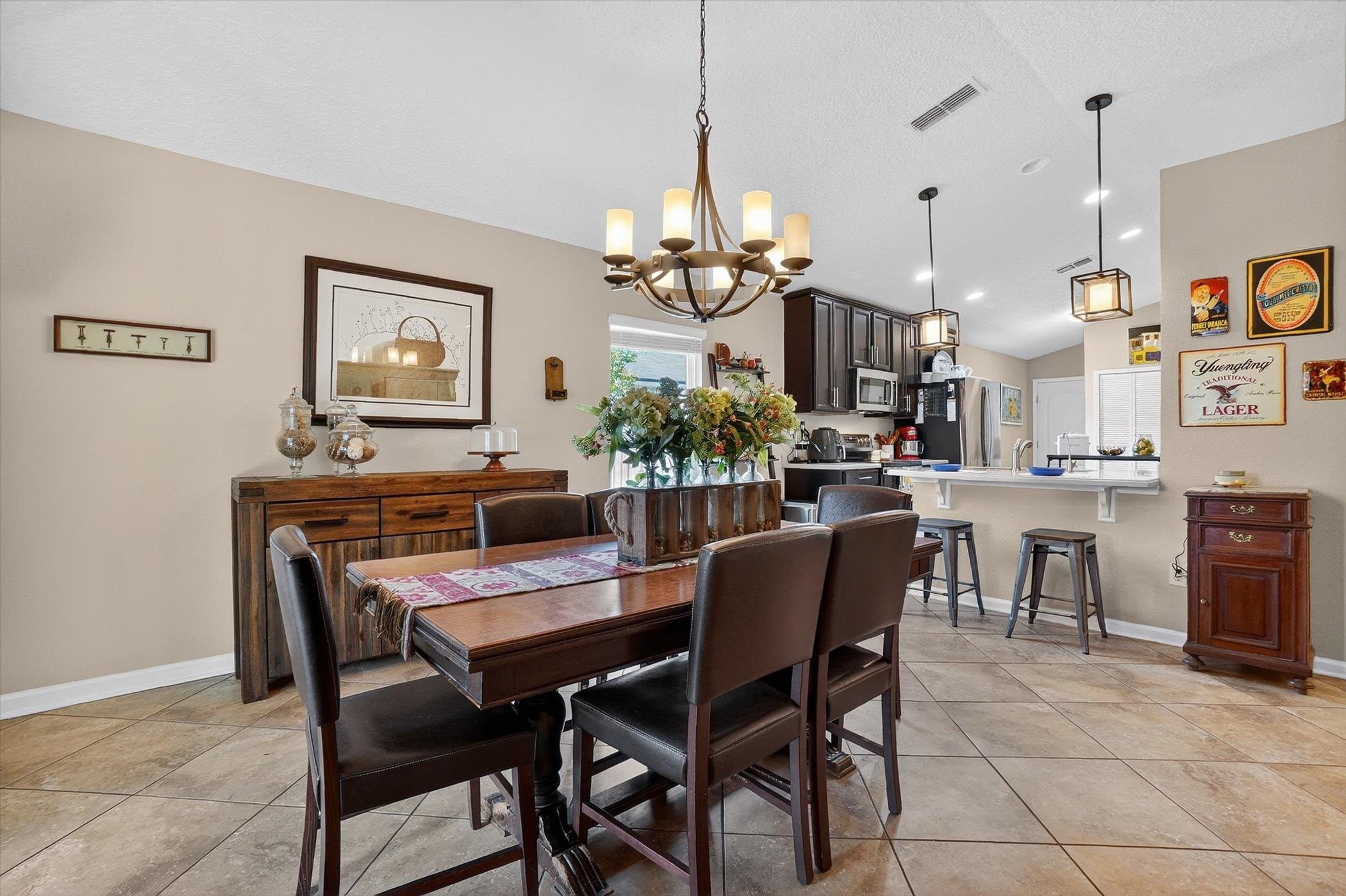 137 Fallen Timber Way St. Augustine, FL 32084 - Photo 15 of 45 Dining room with suspended lighting, vaulted ceiling, and light tile patterned floors