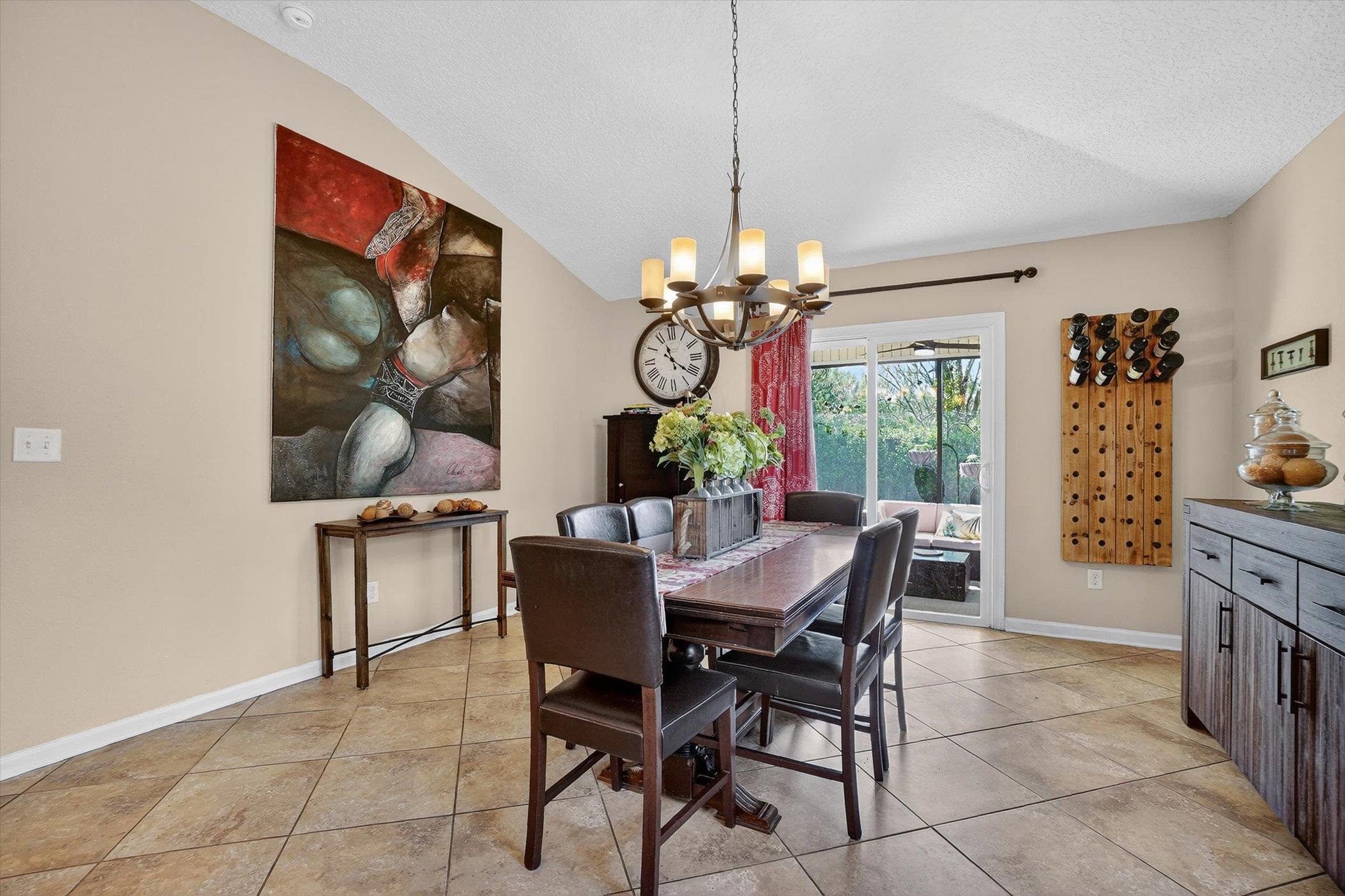 137 Fallen Timber Way St. Augustine, FL 32084 - Photo 16 of 45 Dining space featuring hanging lights, lofted ceiling, and light tile patterned floors