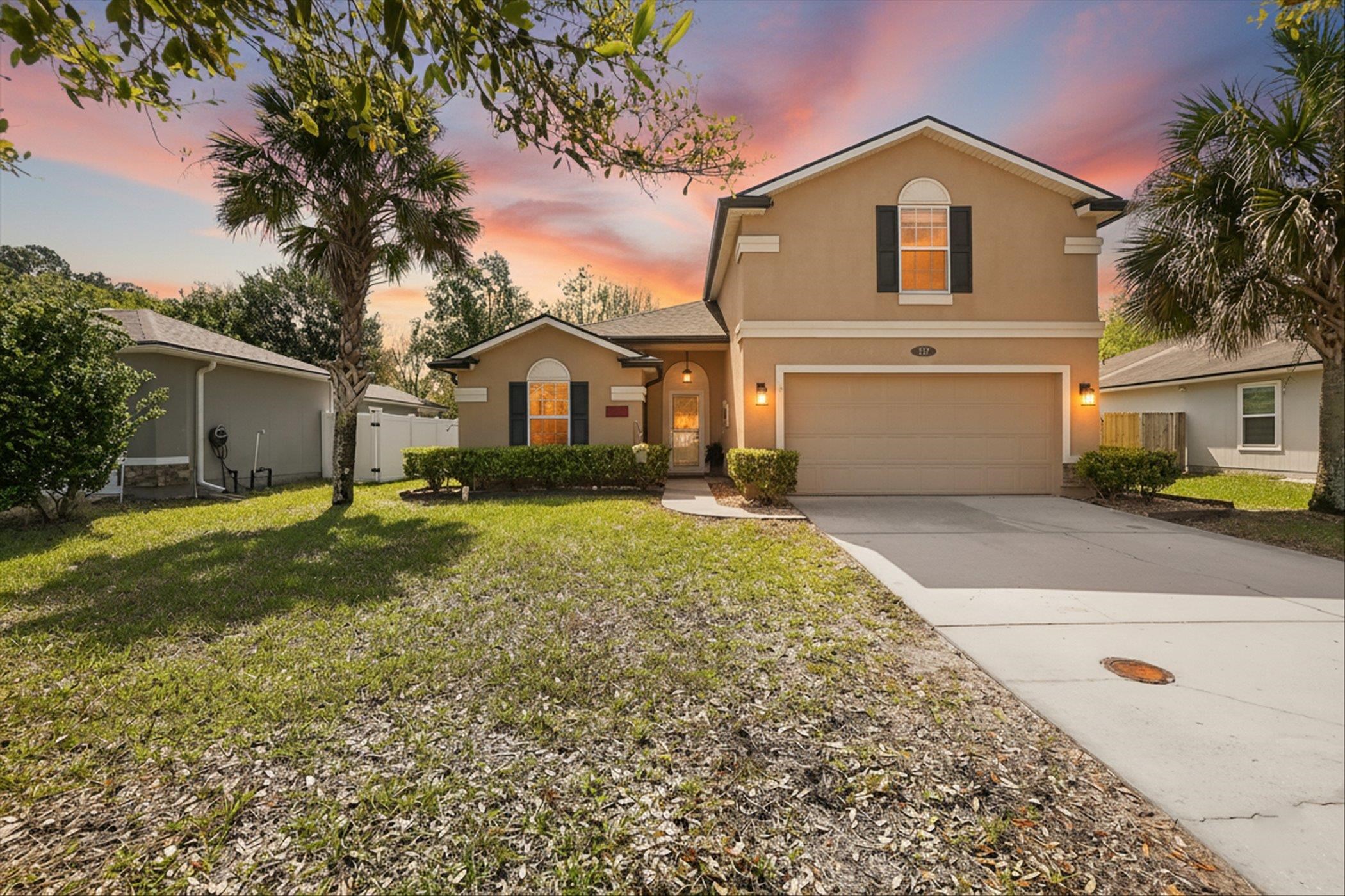 137 Fallen Timber Way St. Augustine, FL 32084 - Photo 2 of 45 View of front of property featuring stucco siding, concrete driveway, a garage, and a gate
