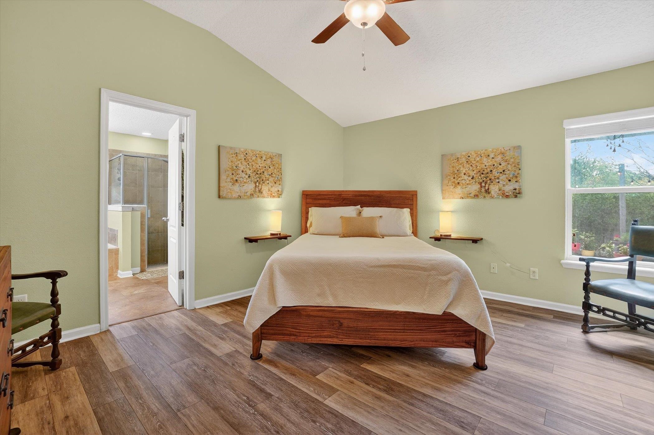 137 Fallen Timber Way St. Augustine, FL 32084 - Photo 22 of 45 Bedroom with wood finished floors, vaulted ceiling, ceiling fan, and connected bathroom