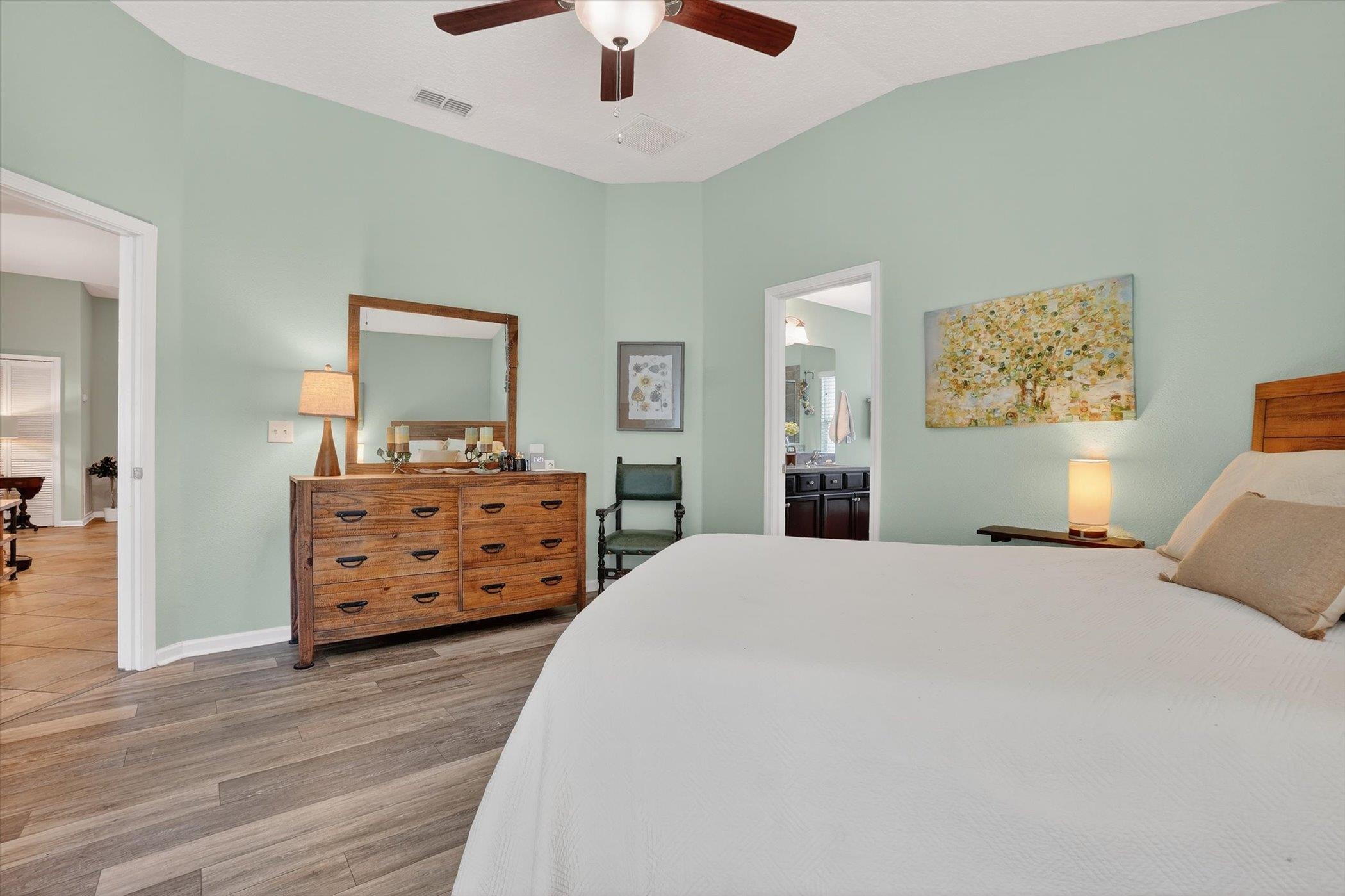 137 Fallen Timber Way St. Augustine, FL 32084 - Photo 24 of 45 Bedroom featuring wood finished floors, ceiling fan, vaulted ceiling, and ensuite bathroom