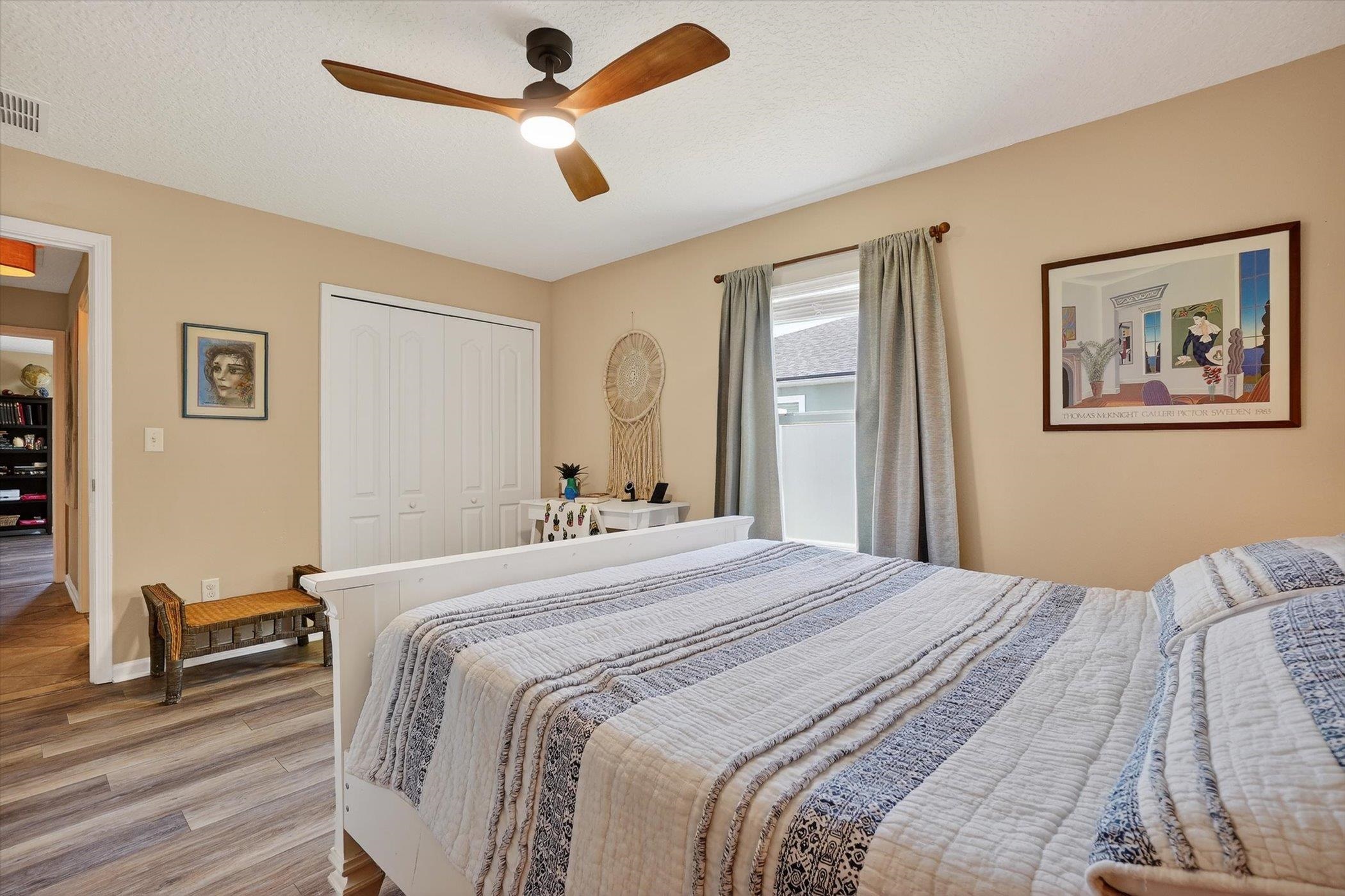 137 Fallen Timber Way St. Augustine, FL 32084 - Photo 27 of 45 Bedroom featuring wood finished floors, ceiling fan, a closet, and a textured ceiling