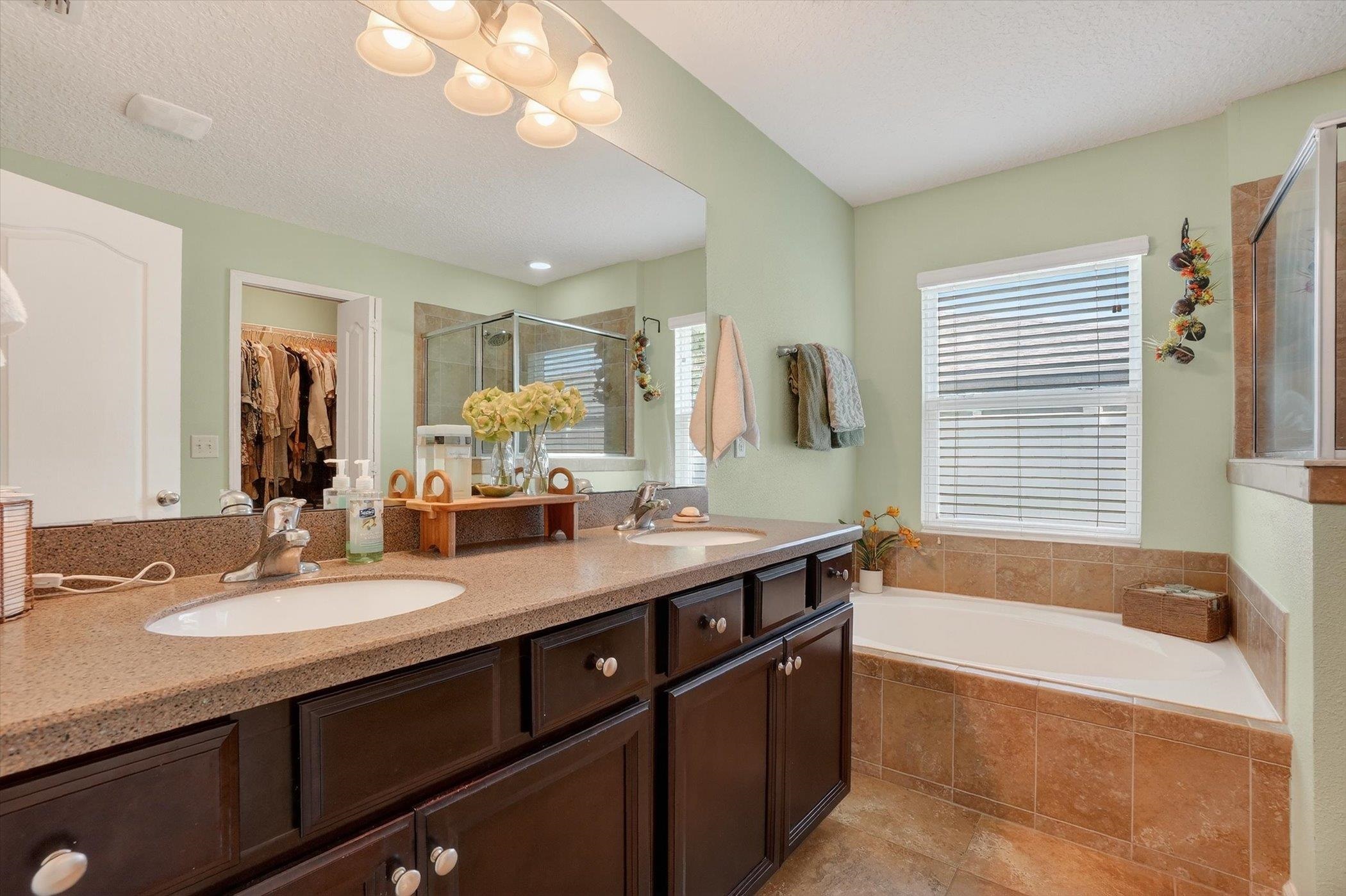 137 Fallen Timber Way St. Augustine, FL 32084 - Photo 28 of 45 Full bathroom with double vanity, a spacious closet, a garden tub, and a shower stall