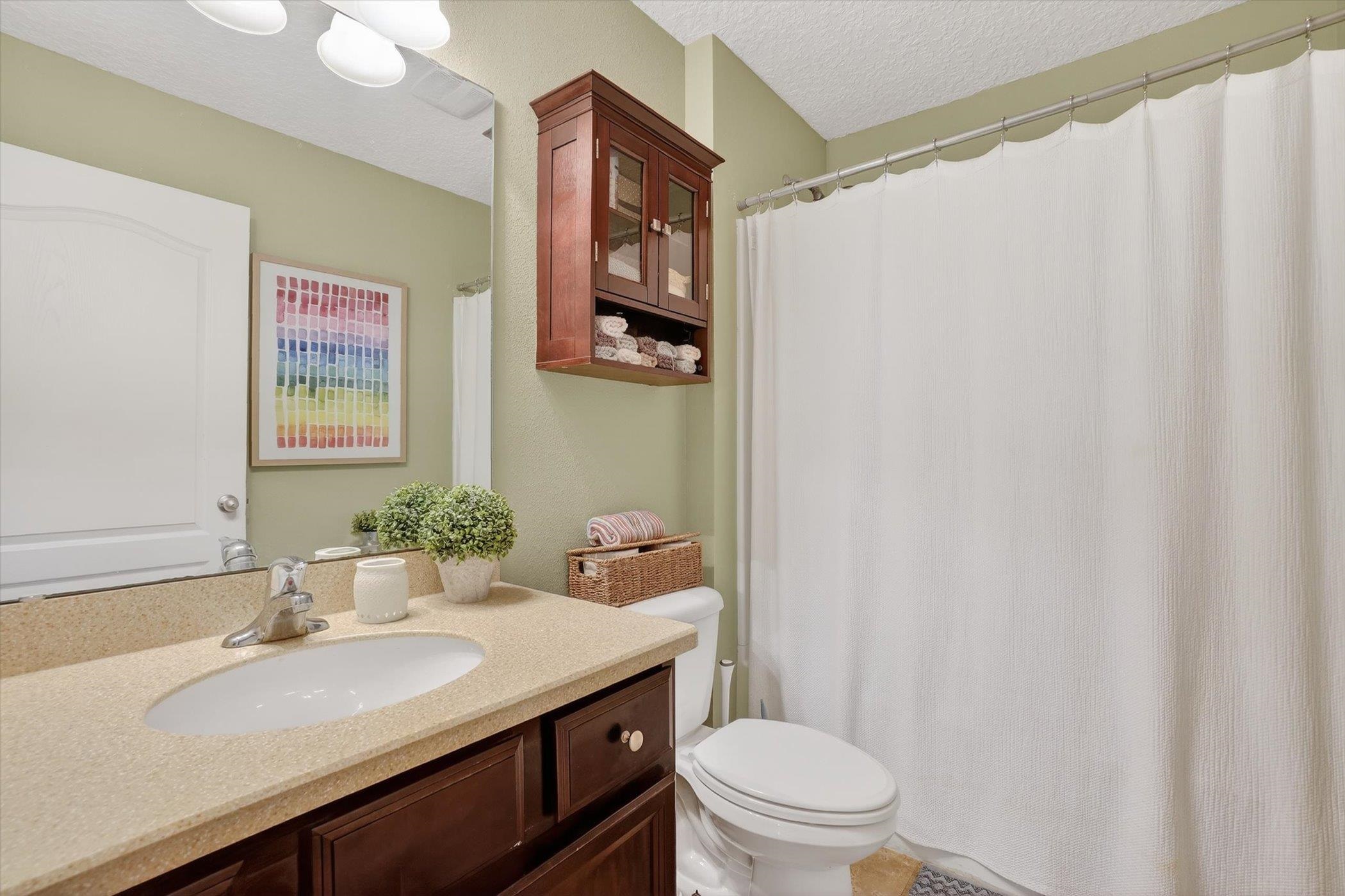 137 Fallen Timber Way St. Augustine, FL 32084 - Photo 29 of 45 Full bathroom featuring vanity, a shower with curtain, and a textured ceiling
