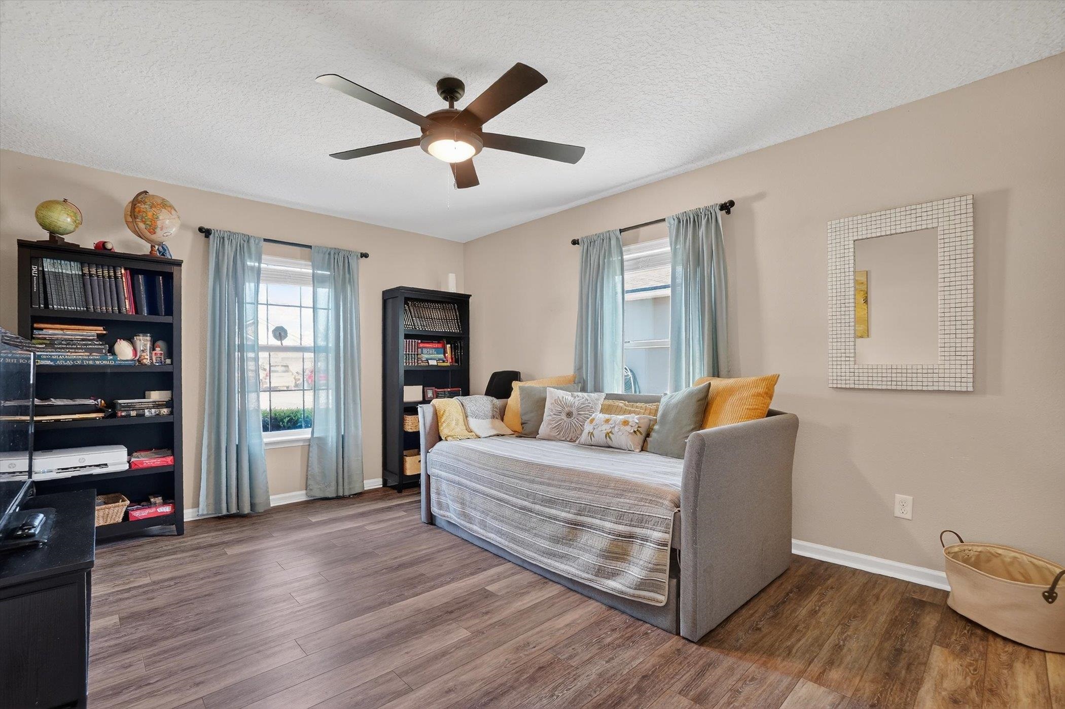 137 Fallen Timber Way St. Augustine, FL 32084 - Photo 30 of 45 Bedroom with dark wood finished floors, ceiling fan, multiple windows, and a textured ceiling