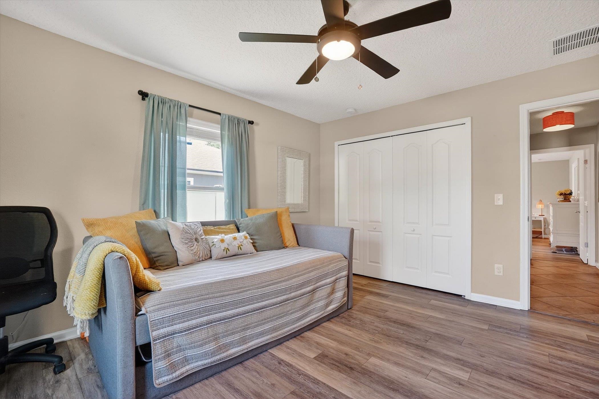 137 Fallen Timber Way St. Augustine, FL 32084 - Photo 31 of 45 Bedroom featuring wood finished floors, a closet, ceiling fan, and a textured ceiling