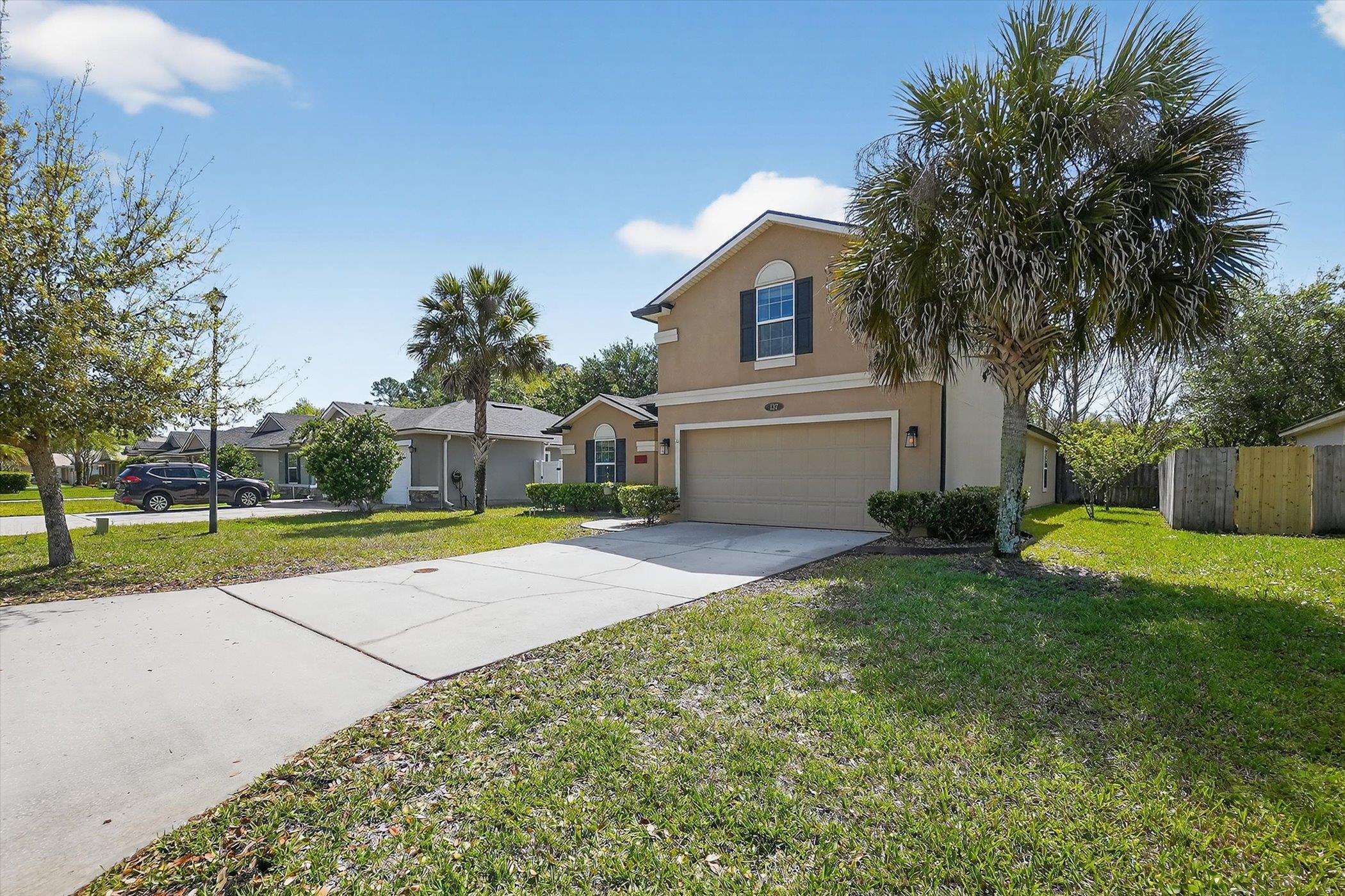 137 Fallen Timber Way St. Augustine, FL 32084 - Photo 36 of 45 Traditional-style house featuring an attached garage, driveway, and stucco siding
