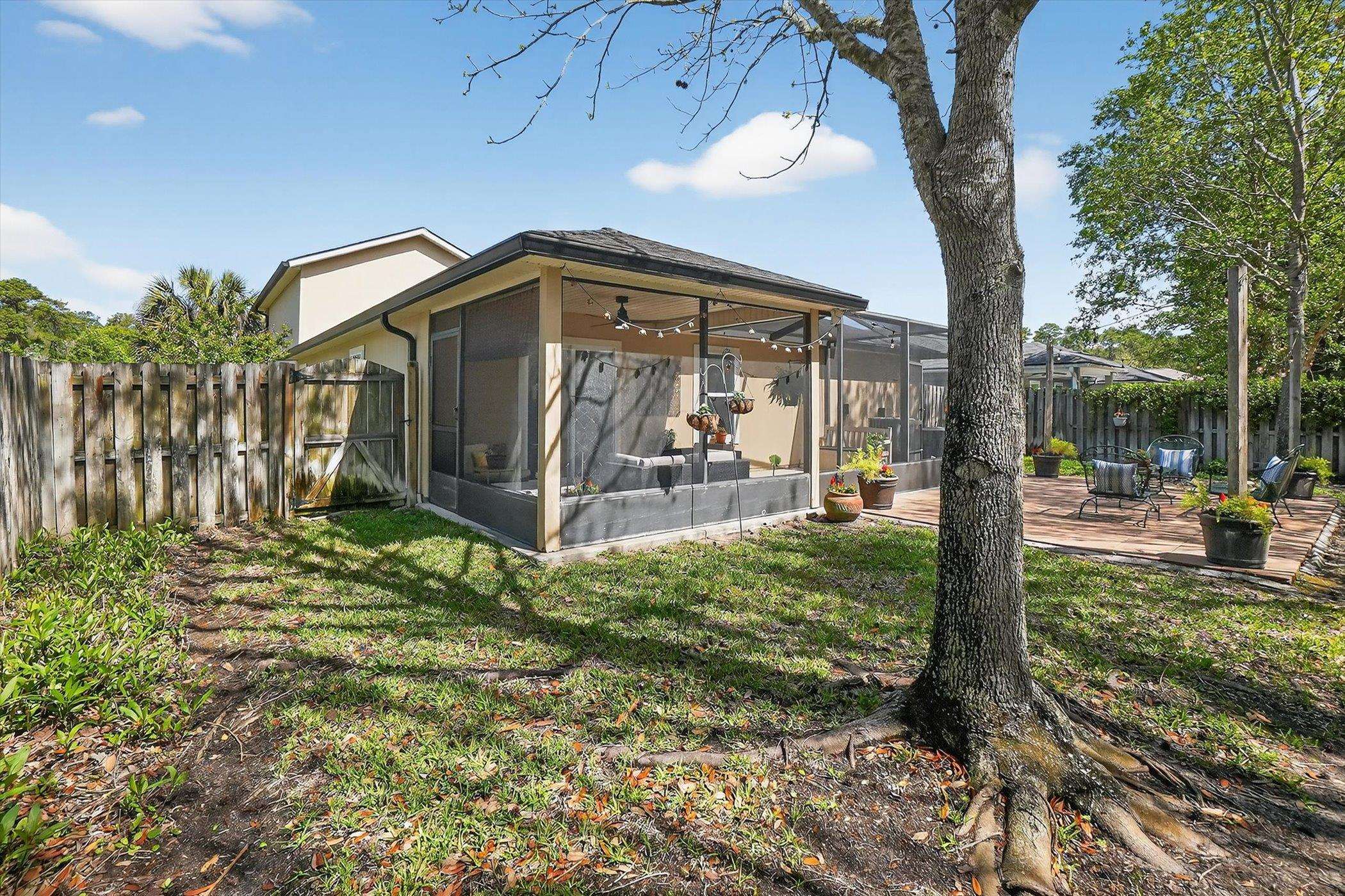 137 Fallen Timber Way St. Augustine, FL 32084 - Photo 40 of 45 Rear view of property with a sunroom, a patio area, and a fenced backyard
