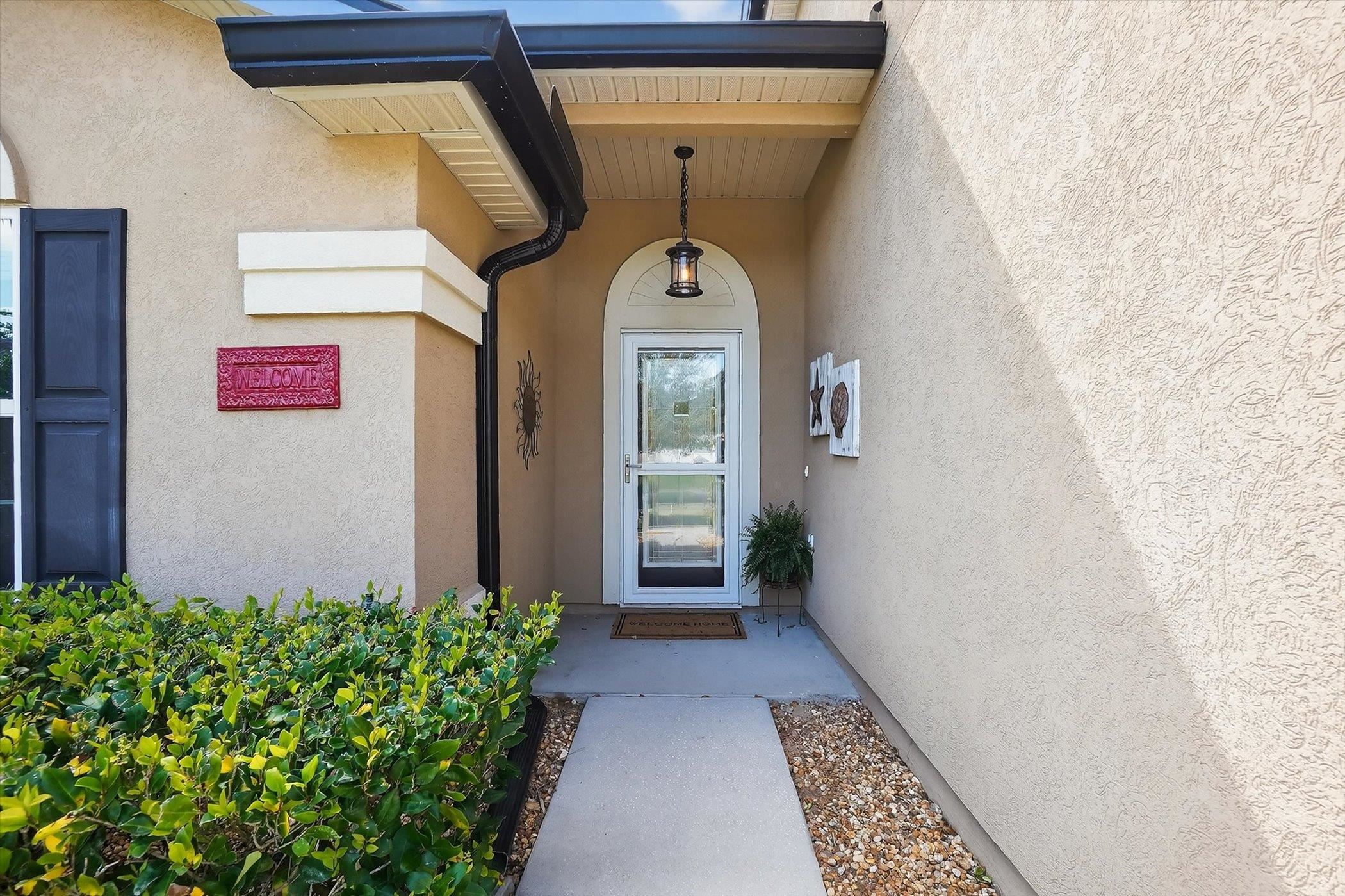 137 Fallen Timber Way St. Augustine, FL 32084 - Photo 6 of 45 Doorway to property with stucco siding