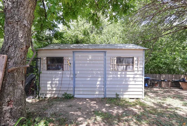 a view of backyard with swimming pool and seating