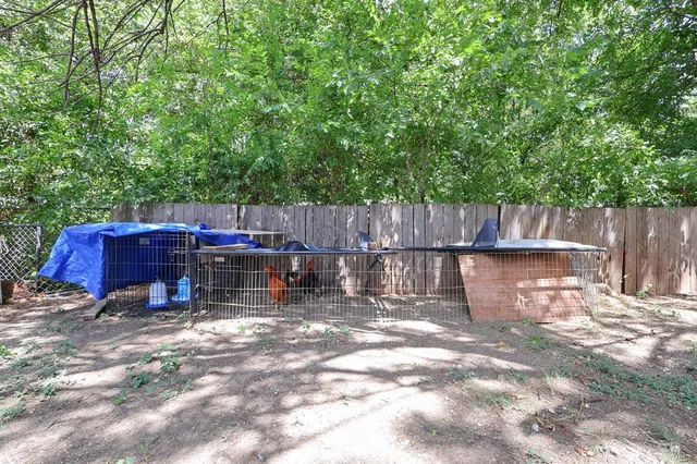 a front view of a house with a tree