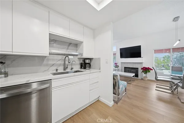 a kitchen with a sink a stove and a microwave