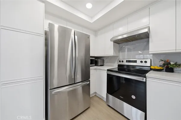 a kitchen with stainless steel appliances a refrigerator stove and microwave