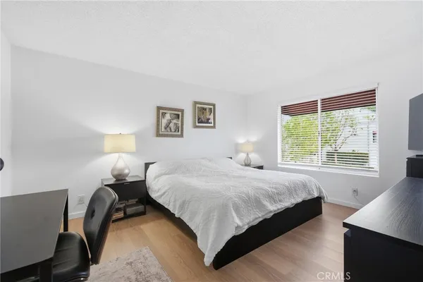a bedroom with a bed and window
