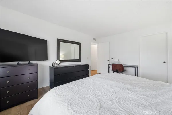 a bedroom with a bed and a flat screen tv
