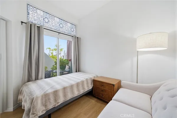 a bedroom with a bed window and a potted plant