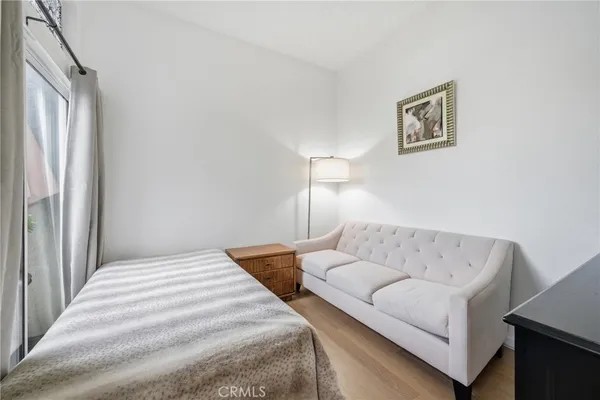 a bedroom with a bed and a couch