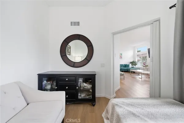 a bedroom with a bed and a mirror