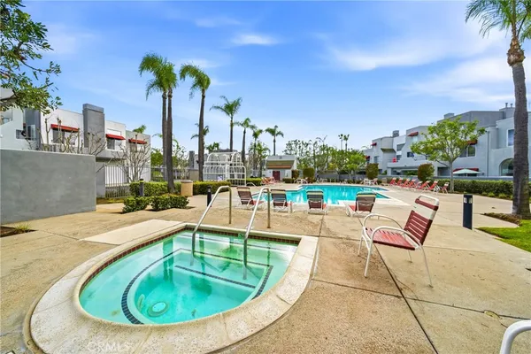 a view of a swimming pool with outdoor seating