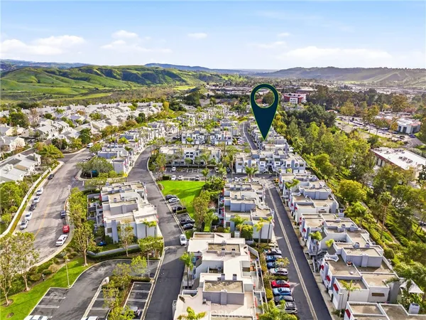 an aerial view of residential houses with outdoor space