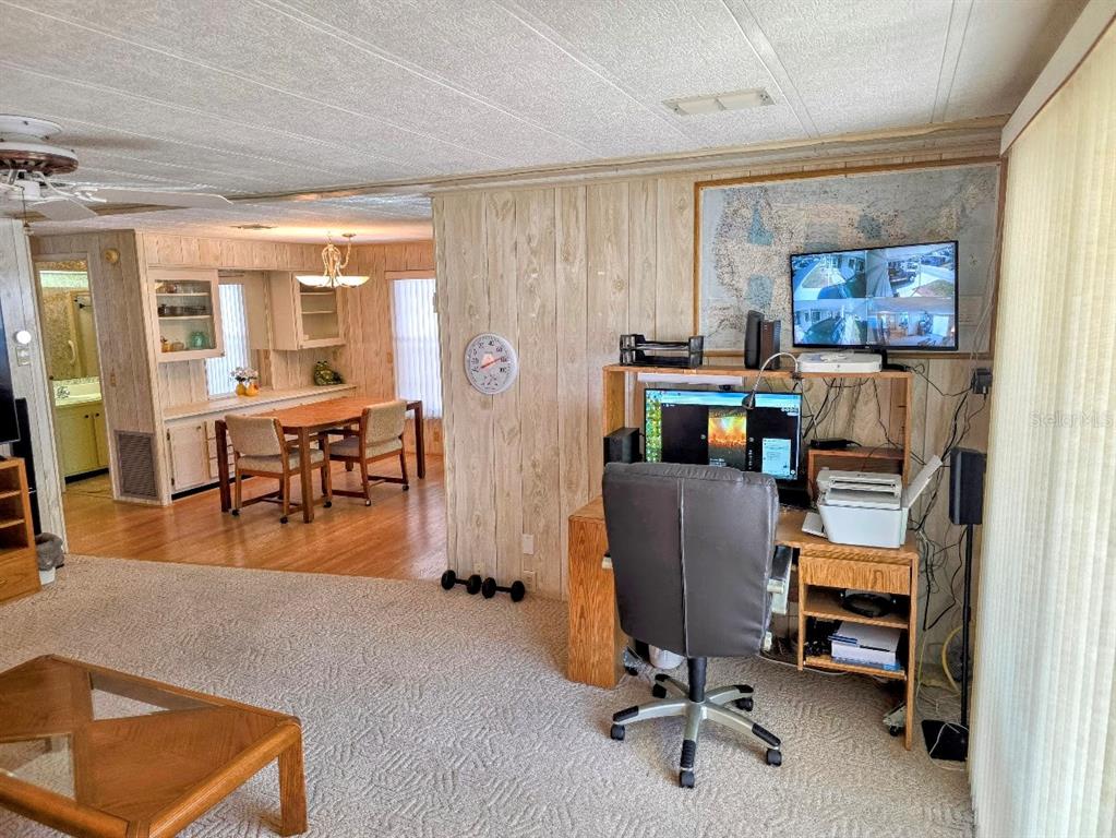12501 Ulmerton Road, Unit 188 Largo, FL 33774 - Photo 16 of 63 a work room with furniture and a wooden floor