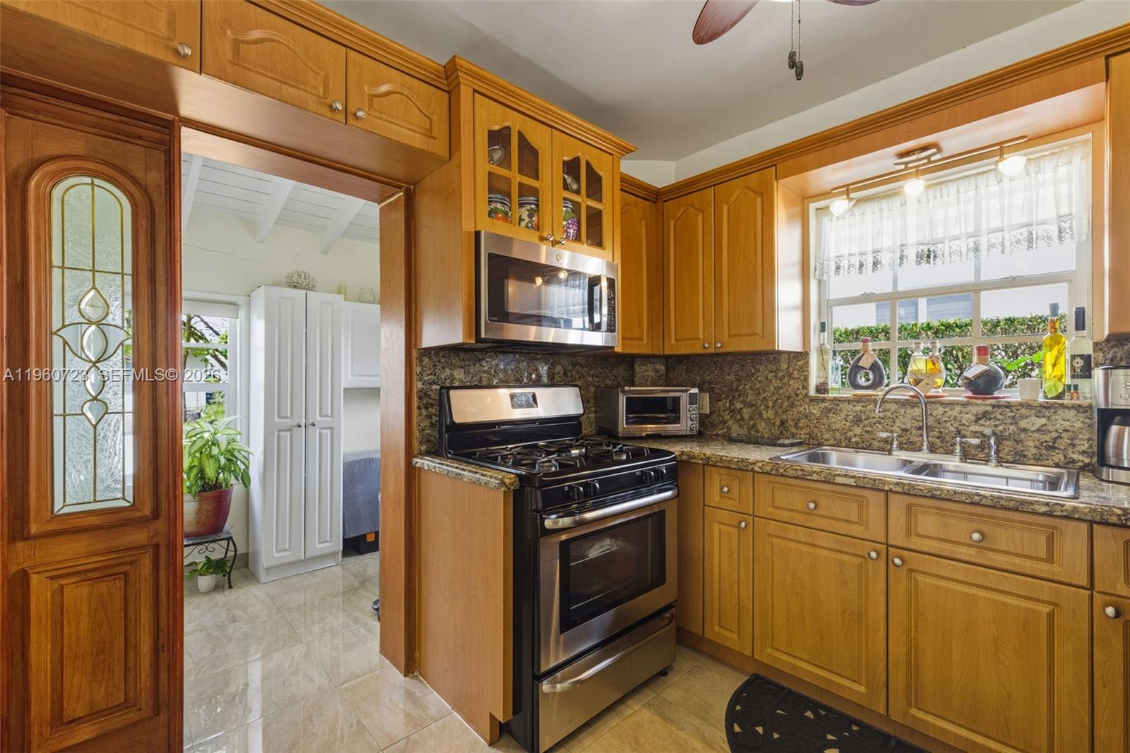 Surfside Surfside, FL 33154 - Photo 14 of 42 a kitchen with stainless steel appliances granite countertop a stove and a refrigerator