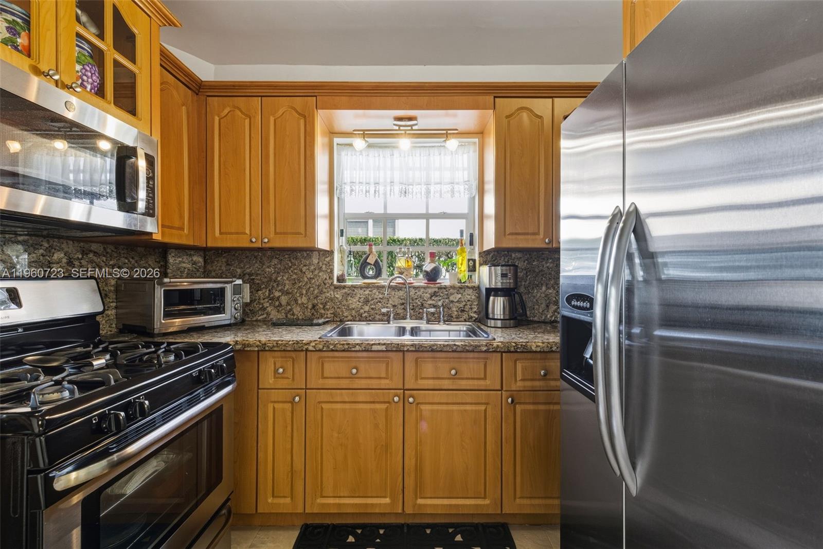 Surfside Surfside, FL 33154 - Photo 15 of 42 a kitchen with stainless steel appliances granite countertop a stove a sink and a microwave
