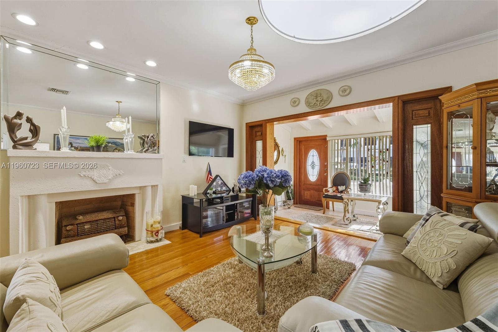 Surfside Surfside, FL 33154 - Photo 8 of 42 a living room with furniture a fireplace and a chandelier