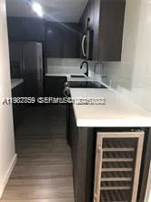 a kitchen with a sink a stove and cabinets