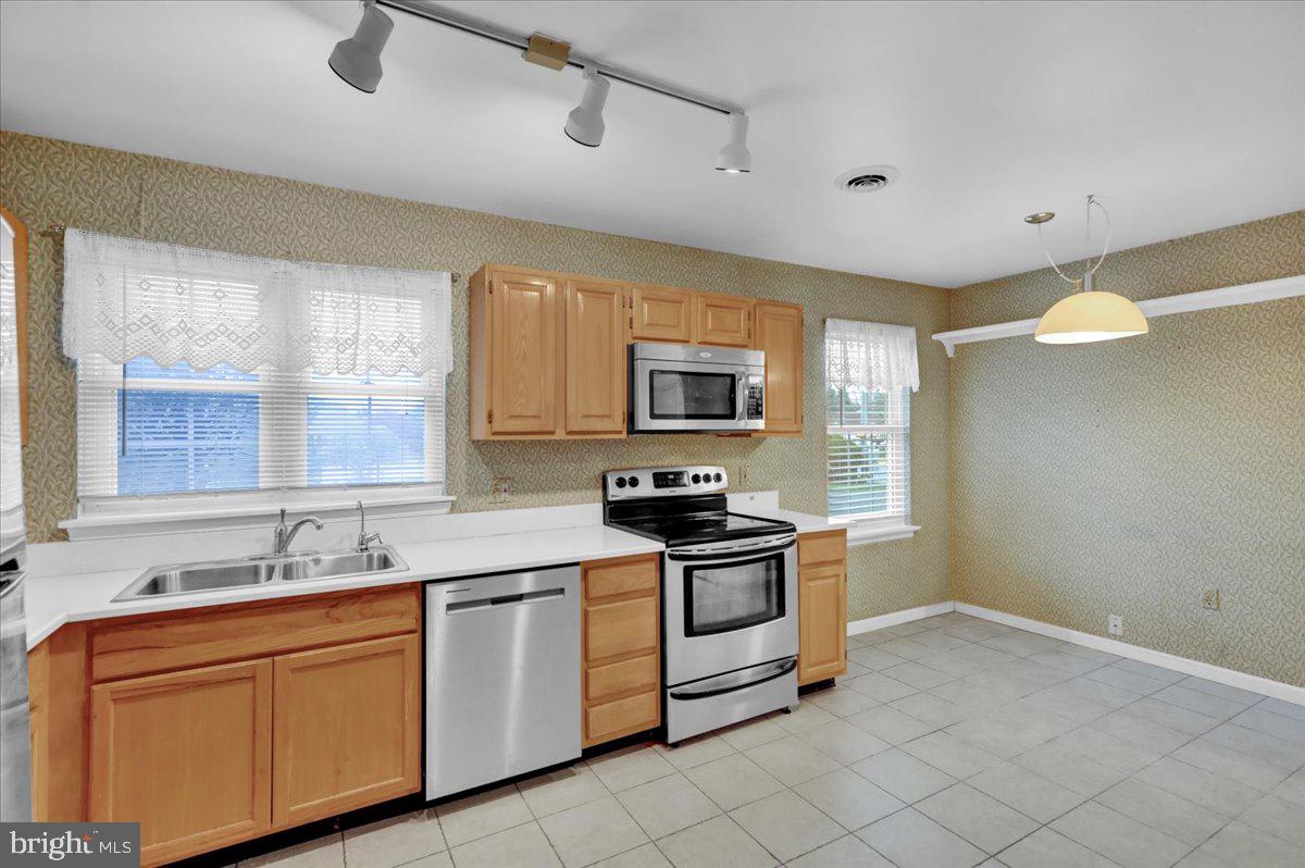 101 Heather Lane Reading, PA 19610 - Photo 15 of 38 a kitchen with stainless steel appliances granite countertop a sink and a stove top oven