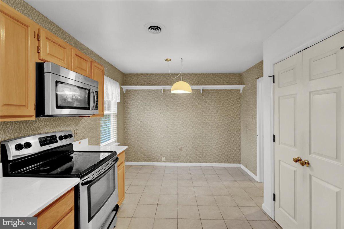 101 Heather Lane Reading, PA 19610 - Photo 16 of 38 a kitchen with granite countertop a stove and a microwave