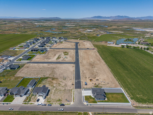 3150 South 5250 West, Unit 210 Hooper, UT 84315 - Photo 8 of 11 Expansive land parcel featuring developed roads, existing infrastructure, and new construction homes