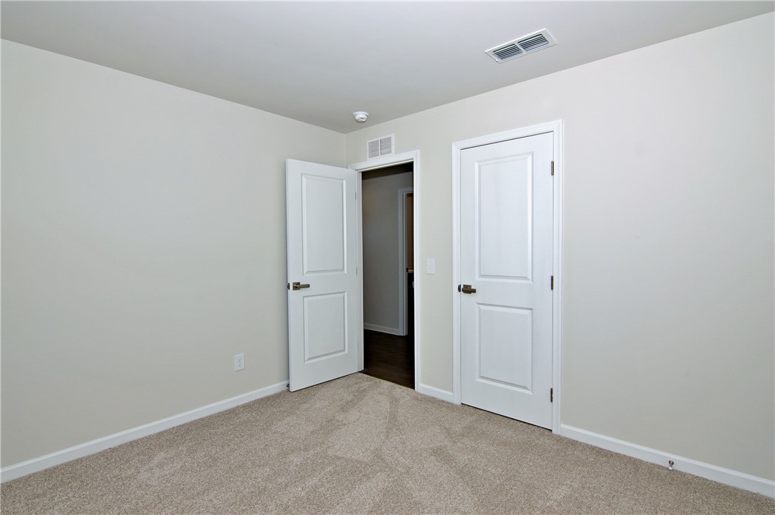 723 Peridot Way Westminster, SC 29693 - Photo 27 of 45 A well-lit room featuring neutral carpet flooring and white paneled doors.