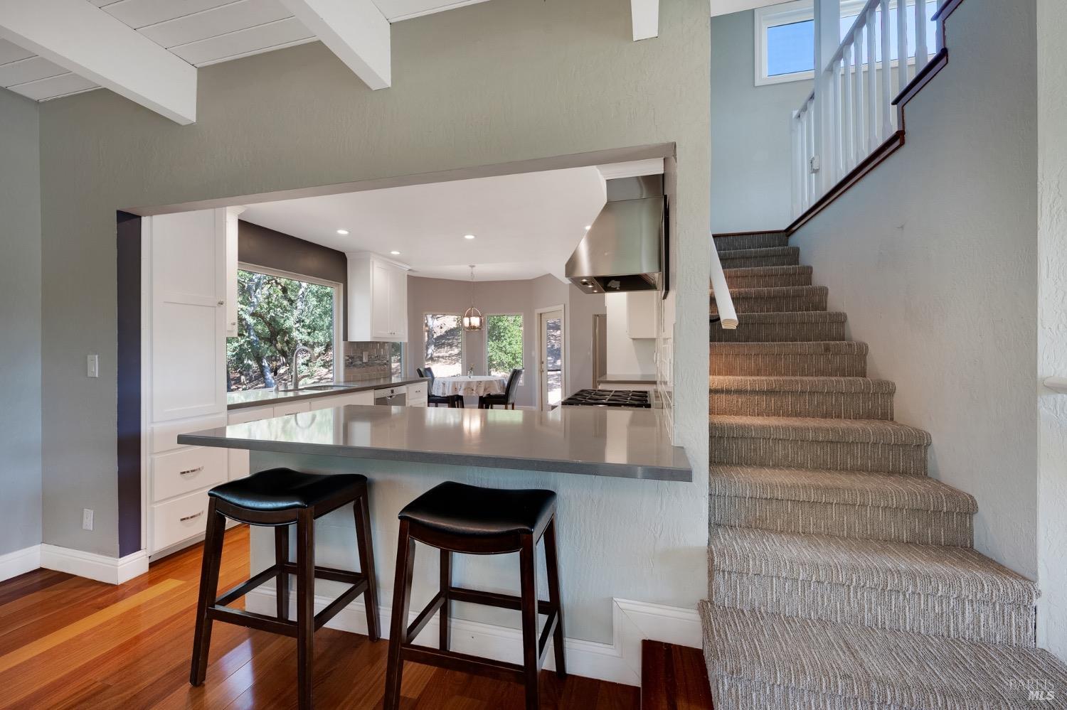 4727 Woodview Drive Santa Rosa, CA 95405 - Photo 24 of 46 a kitchen with stainless steel appliances kitchen island a table and chairs in it