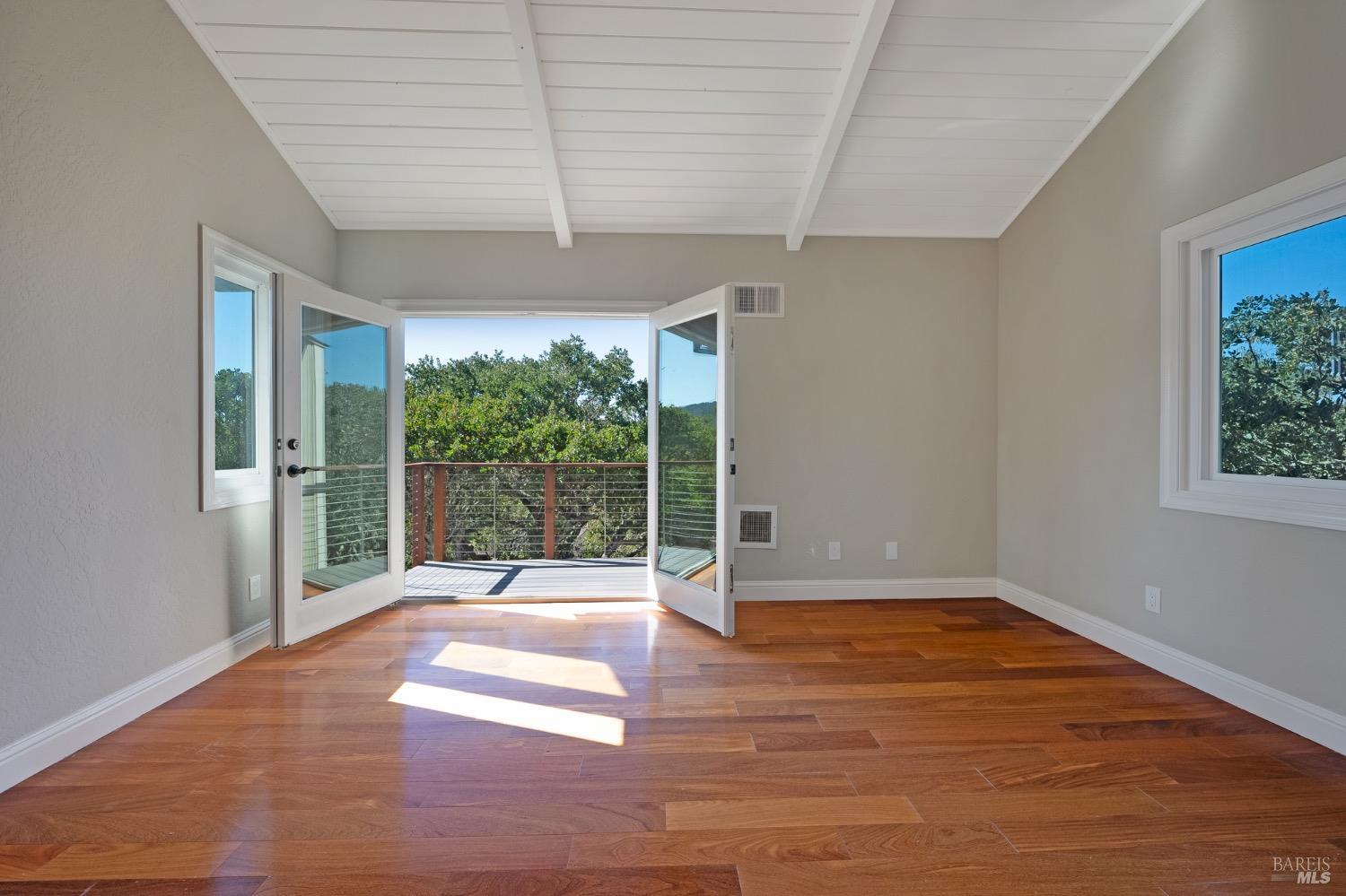 4727 Woodview Drive Santa Rosa, CA 95405 - Photo 42 of 46 a view of an empty room with wooden floor and a window